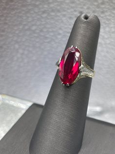 a ring with a large red stone on it