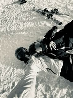 a man laying in the snow on his back