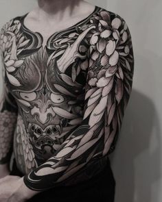 a man with lots of tattoos on his chest