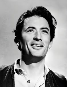 a black and white photo of a man with a smile on it's face