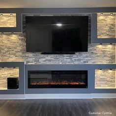 a television mounted on the wall above a fireplace