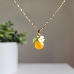 Elevate your style with your exquisite, personalized orange fruit necklace. You choose the design. We hand make the necklace for you. We offer various colors and materials to choose. The necklace is delicately crafted with intricate details, capturing the beauty of nature in its design. Lightweight and comfortable to wear 🍊Premium Material: handmade with Czech glass oranges, acrylic flowers, acrylic leaves, and 14K gold plated/925 sterling silver plated (hypoallergenic) necklace chain. 🌺 Size: Orange Jewelry With Fruit Design For Gifts, Orange Fruit Design Jewelry For Gift, Orange Fruit Design Jewelry Gift, Orange Pendant Charm Necklaces For Gifts, Orange Charm Jewelry For Gifts, Orange Dainty Jewelry For Gifts, Dainty Orange Jewelry For Gifts, Dainty Orange Jewelry For Gift, Orange Flower Pendant Jewelry For Gift