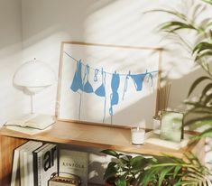 an image of clothes hanging out to dry on a line with books and plants in the foreground