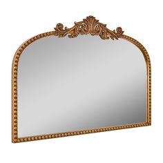 an ornate gold framed mirror on a white background