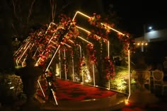 A customised entry porch created for a sangeet ceremony, decorated with led lights and flowers. Sangeet Entry Passage Decor, Sangeet Stage Decor With Led Screen, Sangeet Entry Decor, Event Entry Gate Design, Sangeet Led Stage, Marriage Entry Gate Decoration, Sangeet Theme Ideas, Sangeet Entrance Decor, Event Entrance Decor