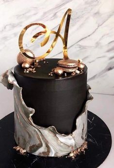 a black and white cake with gold decorations