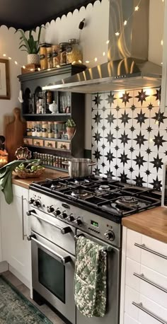 a stove top oven sitting inside of a kitchen next to a wall mounted pot rack