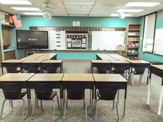 an empty classroom with desks and chairs