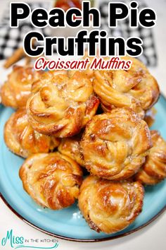 a blue plate topped with croissant muffins on top of a table