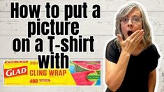 a woman holding her mouth wide open in front of a t - shirt with cling wrap