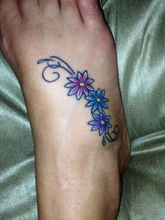 a woman's foot with blue and pink flowers on it