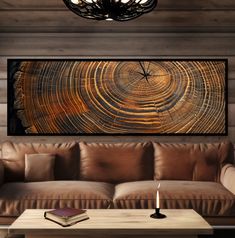 a living room with a couch, table and clock on it's wall above the coffee table