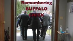 two men in suits walking into a building with the words, remembering buffalo creek