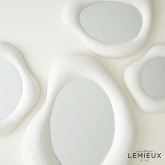 three white oval mirrors sitting next to each other