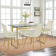 a dining room table with white chairs and a black glass top