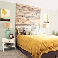 a bedroom with a wooden headboard and yellow bedspread on the bedding