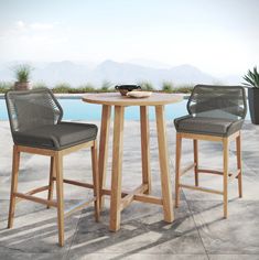 two chairs and a table near a pool