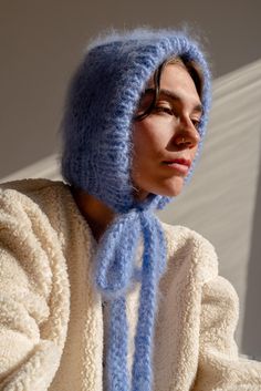 a woman wearing a blue hat and scarf