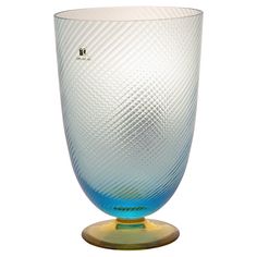 a blue glass vase sitting on top of a yellow base