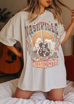 "Nashville Tee, Nashville T-shirt, Music City, Tennessee Tee, Vintage Inspired T-shirt, Unisex Tee, Comfort Colors T-shirt ✧ WHY YOU'LL LOVE IT ✧ ⋒ Comfort Colors® tees are garment-dyed shirts that are timeless classics and will never pile. ⋒ Trendy retro vintage look and gorgeous colors. ⋒ Amazingly soft and comfy. Perfect with any shorts, skirts, jeans, leggings, or nothing but undies around the house. ⋒ Created with quality in mind, it's made from 100% ring-spun cotton. ⋒ Will last for years Summer Music-themed Tops With Graphic Design, Summer Music-themed Graphic Tops, Spring Concert T-shirt With Graphic Design, Pop Culture T-shirt For Summer Concert, Music-themed Cotton T-shirt With Graphic Print, Casual Graphic T-shirt For Music Festival, Concert Short Sleeve Top With Graphic Print, Relaxed Fit Short Sleeve T-shirt For Music Festival, Short Sleeve Tops With Graphic Print For Concert