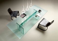 a glass table with some chairs around it