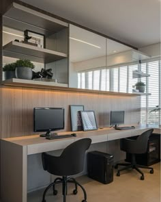 an office with three computers and two chairs