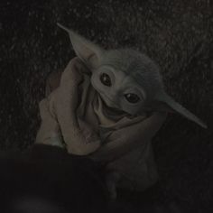 the baby yoda is smiling while wrapped in a blanket