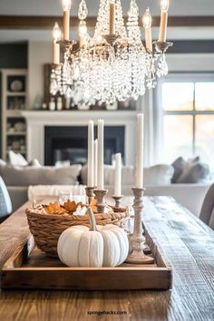 a dining room table with candles, pumpkins and other decorations on top of it