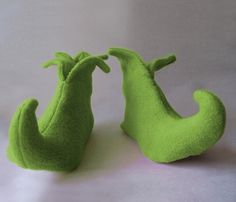 two green stuffed animals sitting next to each other