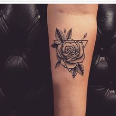 a black and white rose tattoo on the left leg, with an arrow in the middle