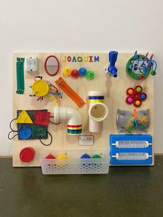 a wooden peg board with various toys on it