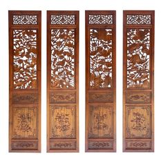 three wooden panels with carved designs on them