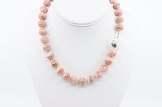 This large gemstone statement necklace is handcrafted with round 12mm all natural AA+ Argentinian pink rhodochrosite beads, highlighted with sterling silver findings and finished with a large handcrafted sterling silver toggle clasp. The rhodochrosite gemstones display lacey striations of pink hues from light soft pink to rich raspberry pink, with minimal dark banding. If you love rhodochrosite, the color pink and want to stand out from the crowd then this statement piece is for you!   The pink Pink Agate Jewelry With 8mm Beads, Pink Opal Round Beads For Jewelry Making, Artisan Pink Jewelry With Round Beads, Pink Opal Round Beads Jewelry, Rhodonite Round Natural Stone Jewelry, Round Rhodonite Jewelry With Natural Stones, Handmade Toggle Necklace With Round Beads As Gift, Pink Round Artisan Jewelry, Handmade Pink Opal Round Jewelry