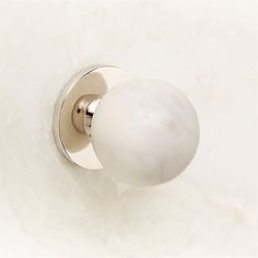 a white door knob with a marble ball on it