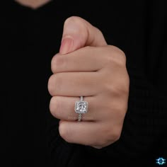 a woman's hand with a diamond ring on it