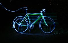 a bicycle is lit up in the dark