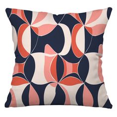 an orange and blue pillow with black circles on the front, against a white background