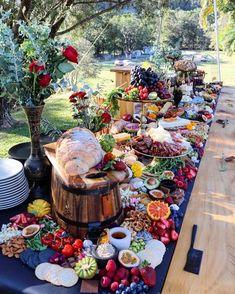 a long table covered with lots of food and flowers on it's side,