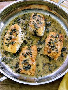 three pieces of fish in a green sauce