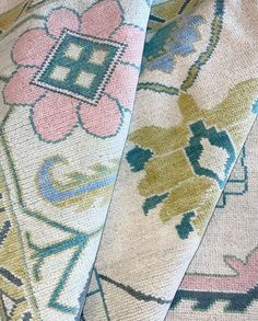 three different colored rugs on top of each other, one with an ornate design