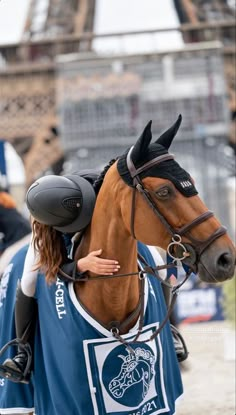 a woman is riding a horse in front of the eiffel tower