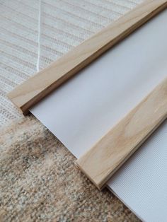 a piece of wood sitting on top of a carpet