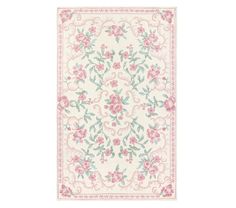 a white rug with pink flowers and green leaves on the bottom, in front of a white background