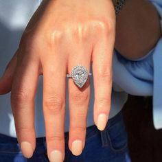 a woman's hand with a diamond ring on it