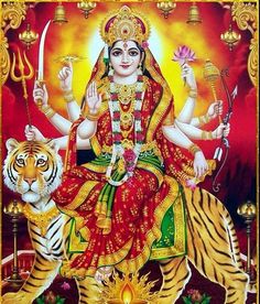 the goddess sitting on top of a tiger in front of a red and yellow background