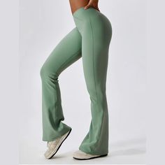 Discover the perfect fusion of style and functionality with these women's high waist flared activewear pants. The high waist design provides excellent tummy control and support, while the elastic waistband ensures a snug yet comfortable fit. The stretchable fabric allows unrestricted movement, making these pants ideal for a range of activities from yoga to dance classes. The flared bottom adds a trendy flair to your gym gear. Stay comfortable, confident, and chic in these versatile activewear pa Mid-rise Solid Pants With Contoured Waistband, Mid-rise Stretch Moisture-wicking Bottoms, Moisture-wicking Stretch Mid-rise Bottoms, High Waist Comfort Stretch Pants With Contoured Waistband, Solid Color Wide Leg Activewear For Fall, Sporty Flare Bottoms For Sports, Casual Mid-rise Yoga Pants With Contoured Waistband, Flared Sports Bottoms With 4-way Stretch, Flare 4-way Stretch Sports Bottoms