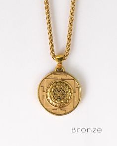 This is a Sri Yantra necklace, a handmade jewelry. This unisex necklace is the perfect gift for him and her any time of the year  Unlock the power of divine geometry and embrace spiritual enlightenment with our handmade Sri Yantra necklace. Immerse yourself in the sacred symbol's profound energy as you embark on a journey of self-discovery and cosmic connection. Handmade with meticulous care and attention to detail, each necklace is a unique expression of spiritual artistry. The Sri Yantra, know Symbolic Bronze Jewelry For Rituals, Spiritual Medallion Jewelry With Si Clarity, Symbolic Pendant Necklace For Rituals, Bronze Amulet Necklace For Blessing, Symbolic Handmade Jewelry For Rituals, Handmade Bronze Jewelry For Blessing, Spiritual Medallion Necklace With Large Round Pendant, Spiritual Round Brass Jewelry, Symbolic Brass Jewelry With Round Pendant