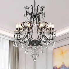 a chandelier hanging from the ceiling in a room with white walls and curtains