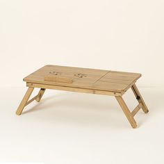 a small wooden table with two smiley faces on it's top and bottom legs