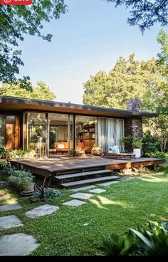 a house that is surrounded by grass and trees